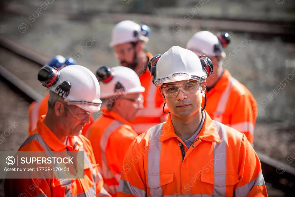 Railway workers standing on train tracks