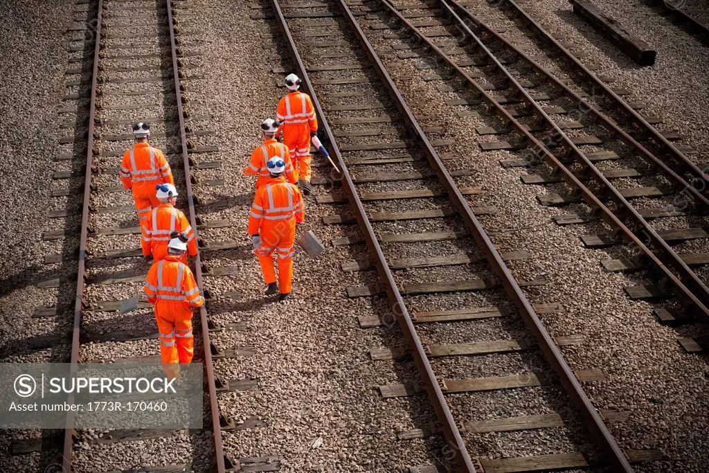 Railway workers walking on train tracks