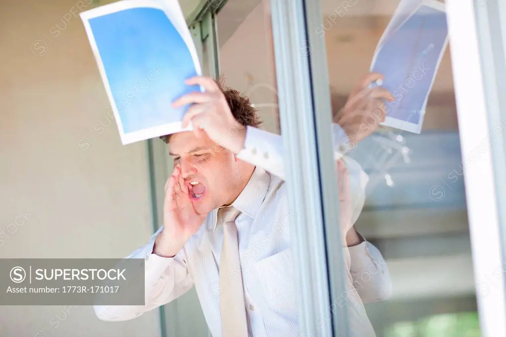 Businessman shouting from office window