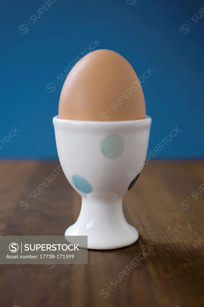 Egg in egg cup on table