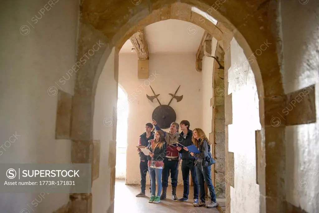 Students examining medieval castle