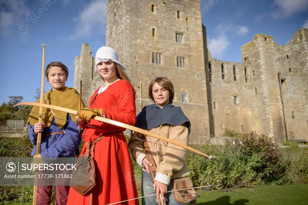 Students in period dress holding weapons