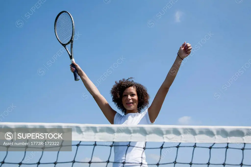 Tennis player cheering on court