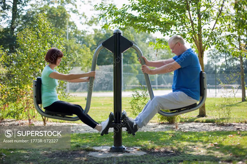 Older couple using exercise equipment