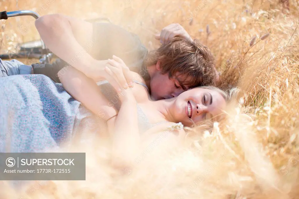 Couple relaxing in tall grass