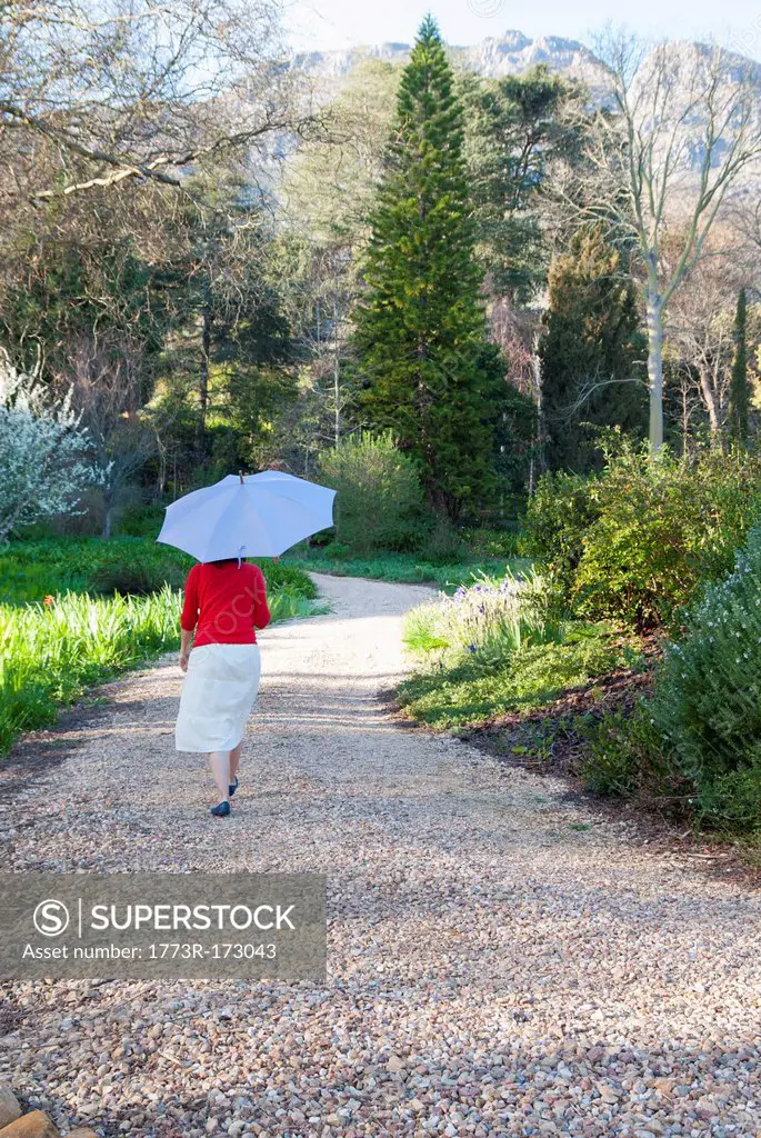 Woman carrying umbrella outdoors