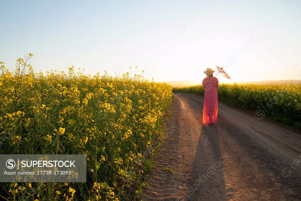 Woman walking on dirt road