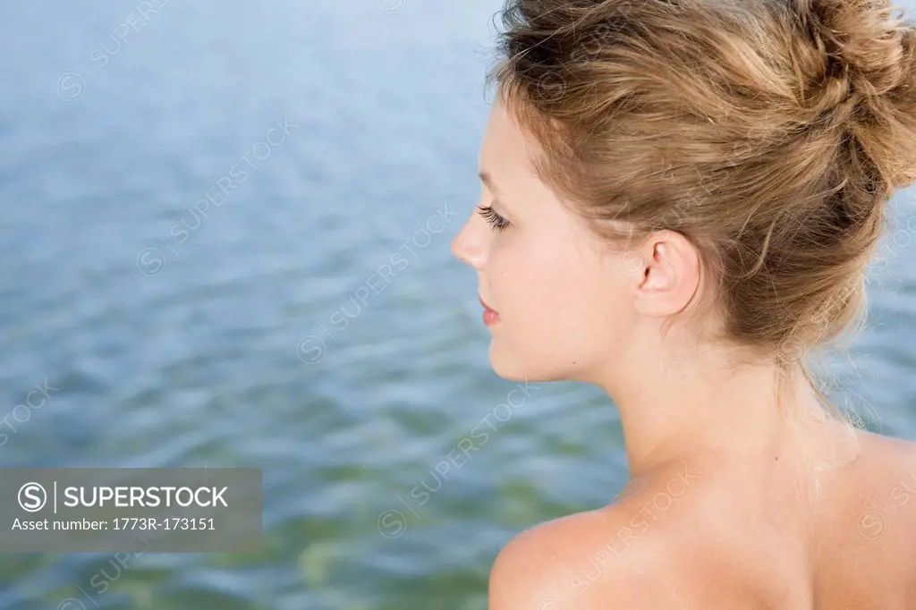 Woman overlooking still lake