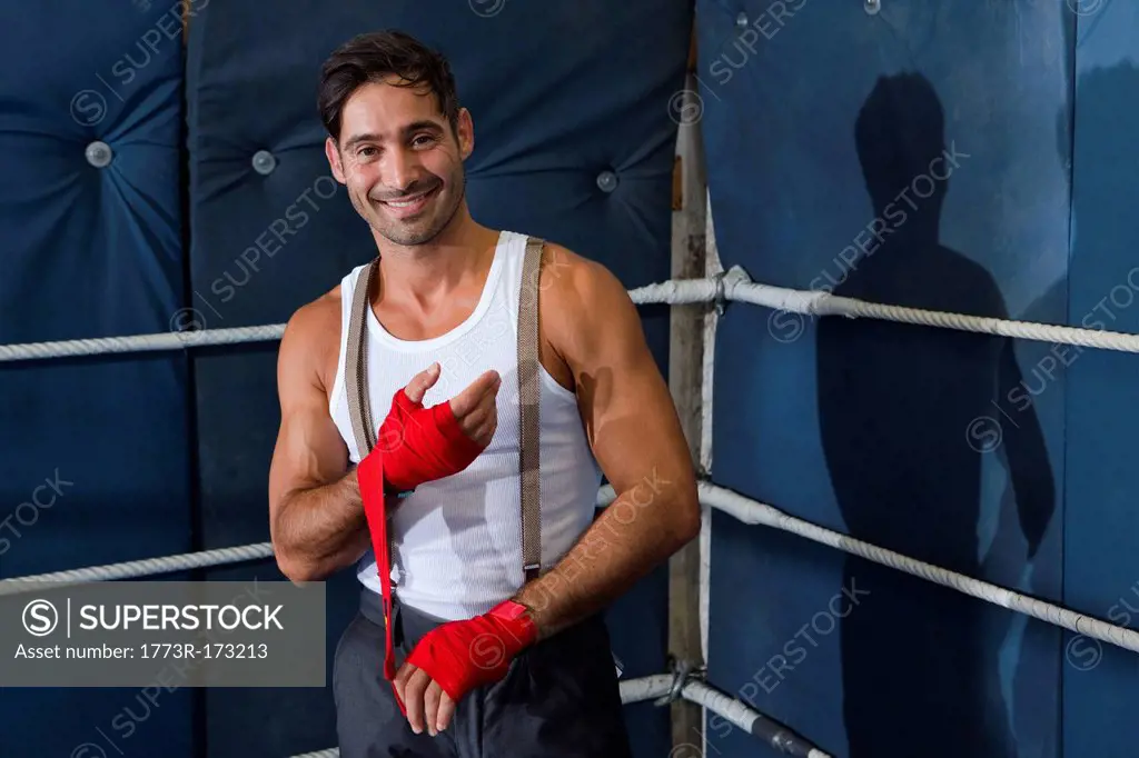 Boxer wrapping his wrists in ring
