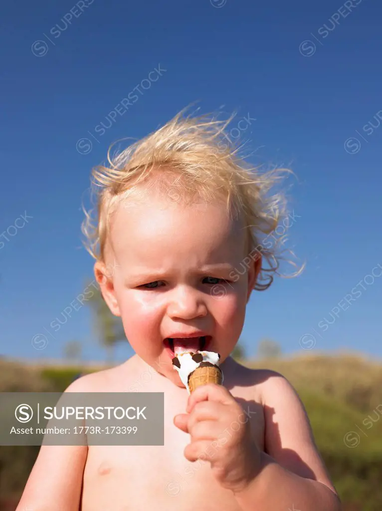 Toddler girl eating ice cream cone