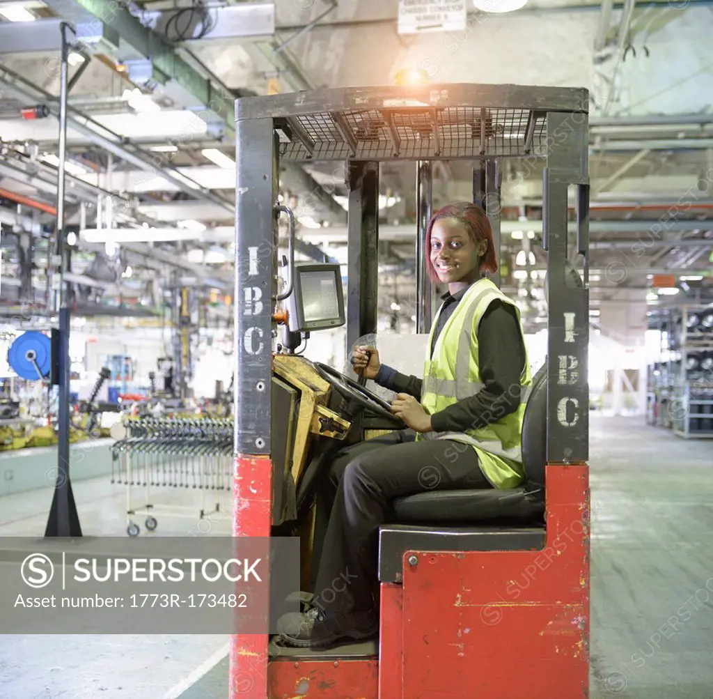 Apprentice lift operator in car factory