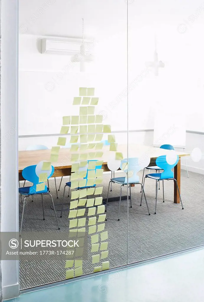 Post-Its stuck on glass wall in the shape of a human
