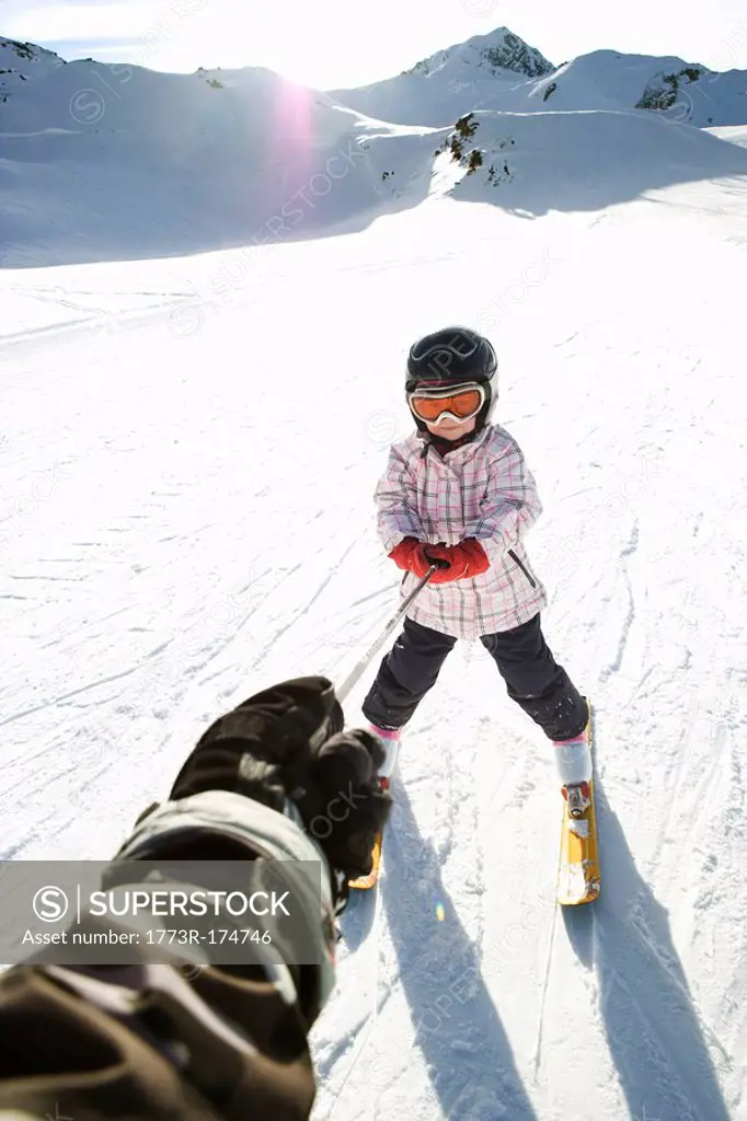 Young girl being towed on skis