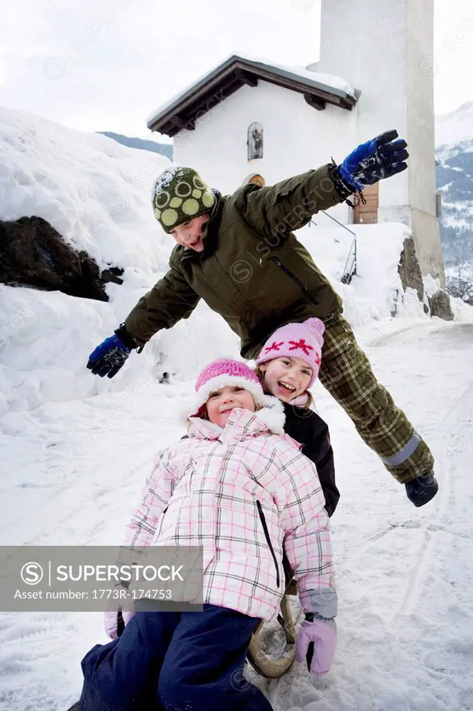 Children sledging down slope