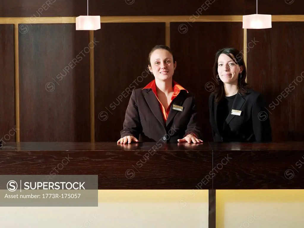 Two hotel receptionists, smiling, portrait