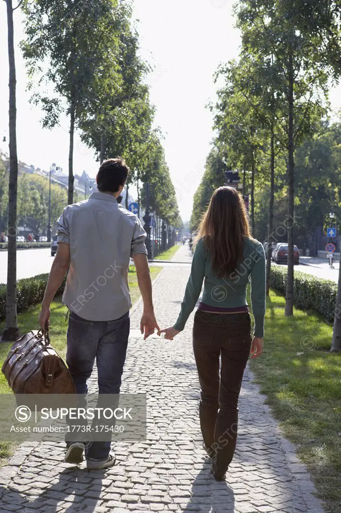 Couple walking together with a large bag
