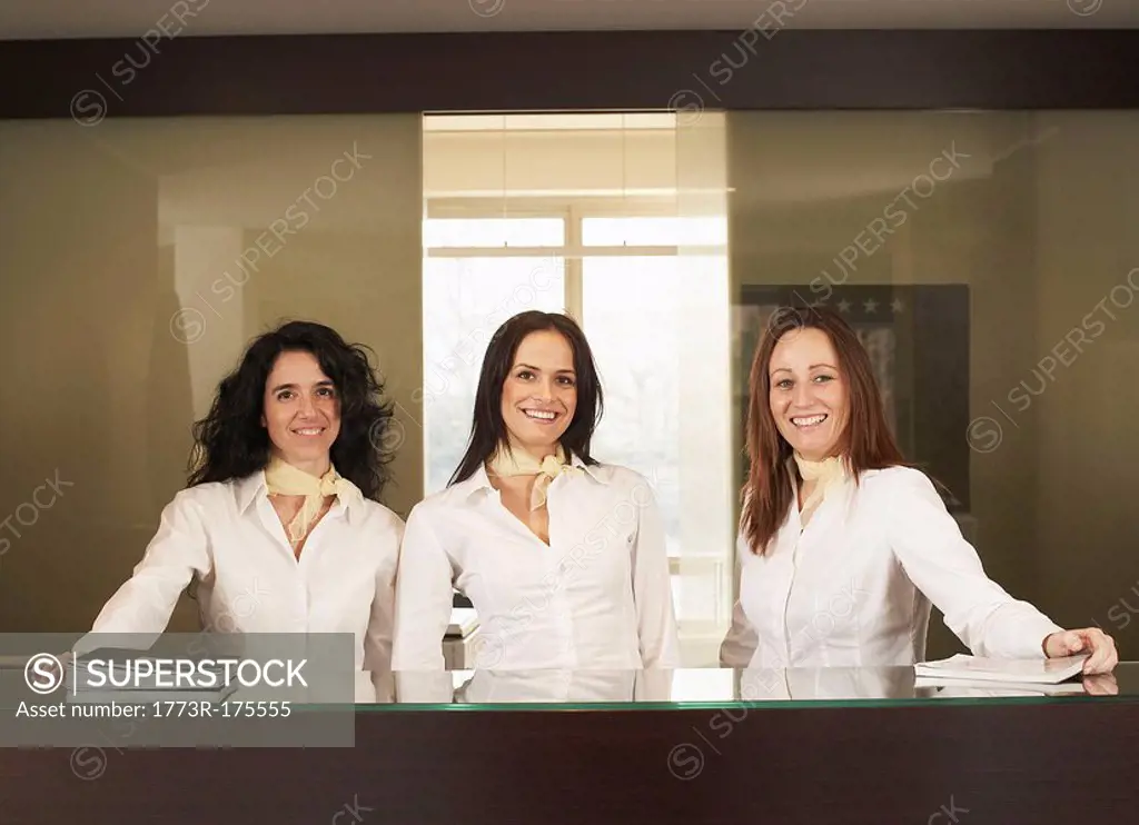 Receptionists behind hotel counter