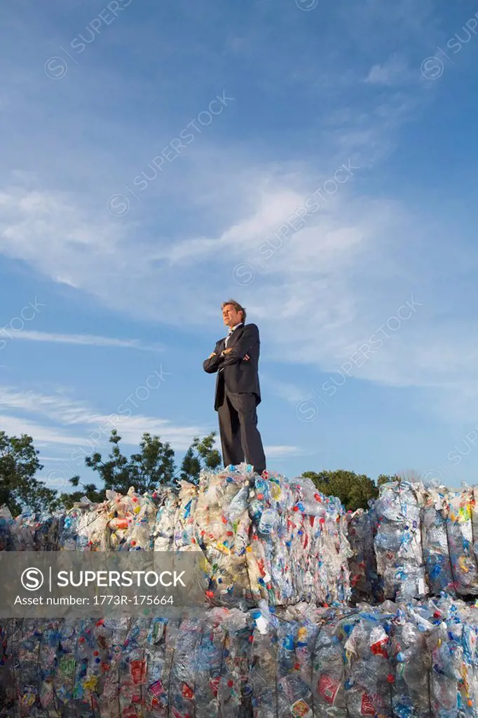 Businessman outdoors at a recycling plant