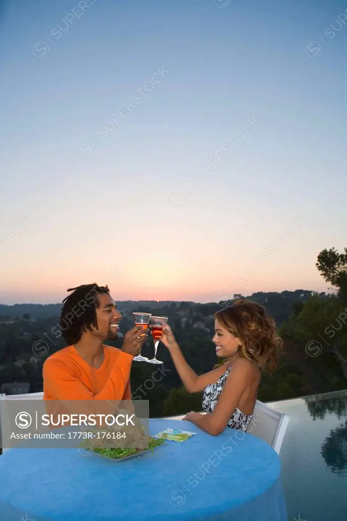 Young couple having dinner at sunset