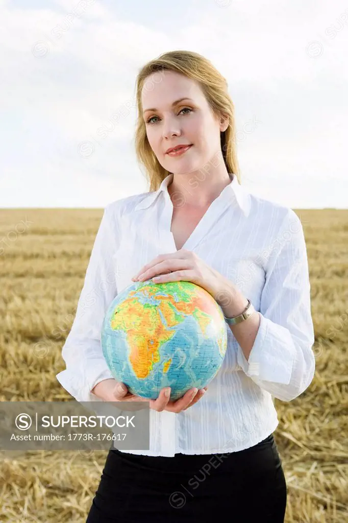 Woman with Globe in wheat field