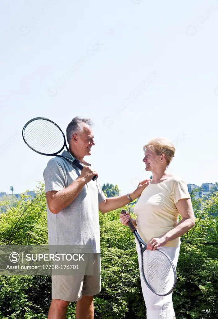 Couple with tennis rackets