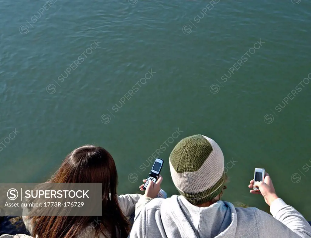 Young couple looking at mobiles