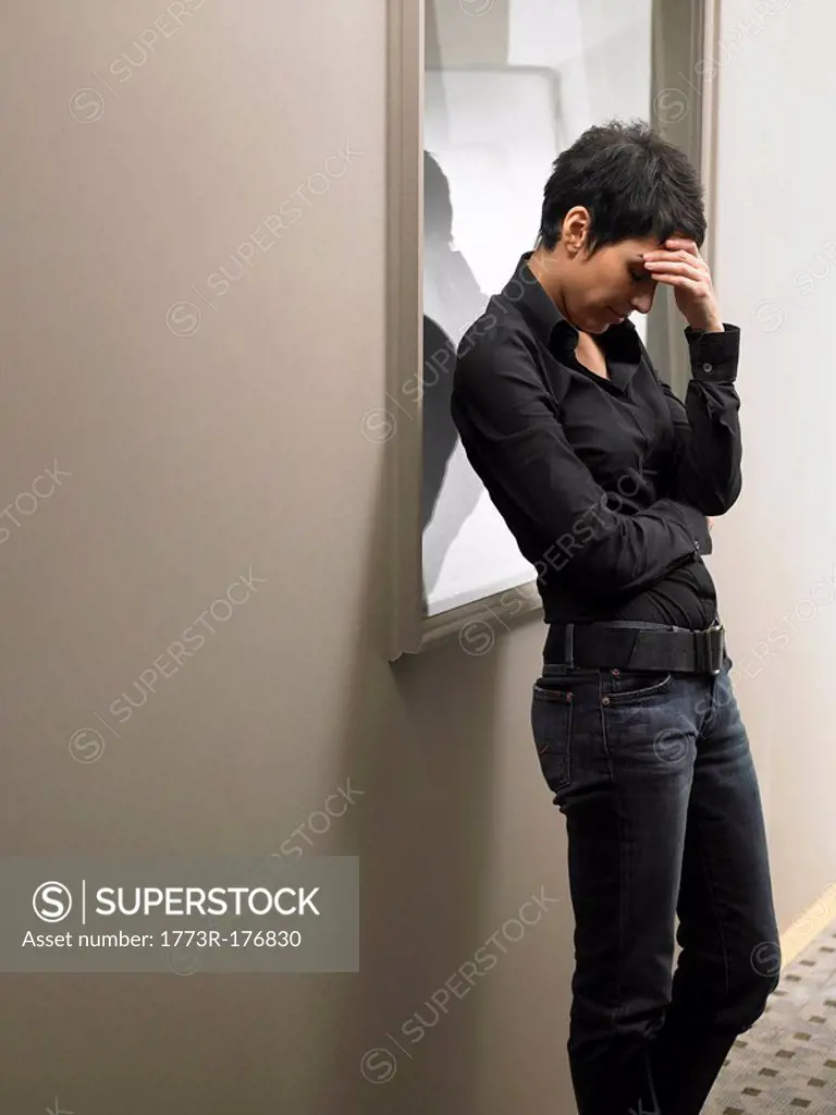 Anxious woman standing in corridor