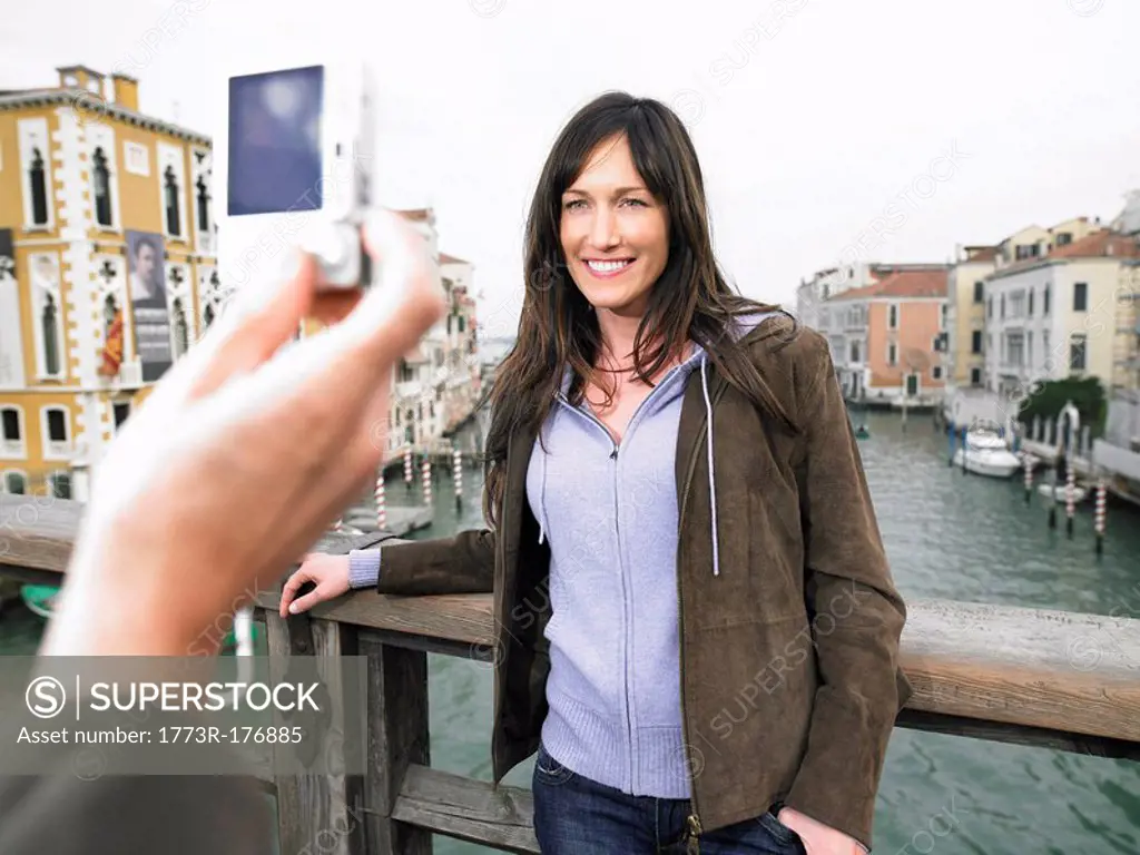 Close up of man´s hand taking photograph of woman Grand Canal, Venice, Italy