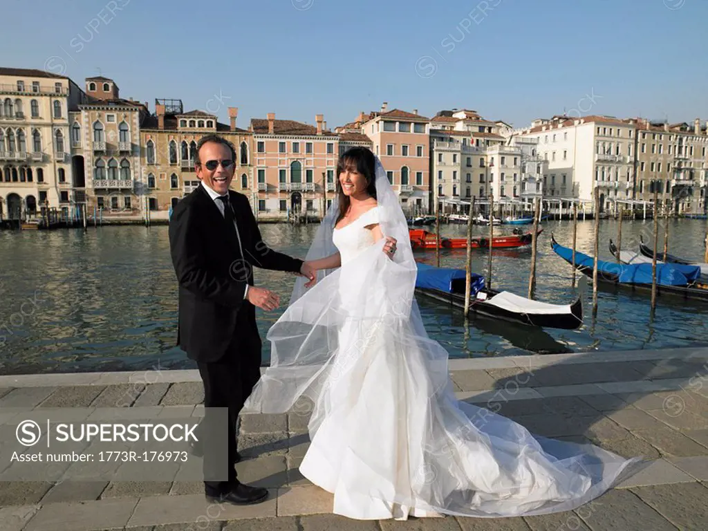 Bride and groom laughing Grand Canal, Venice, Italy
