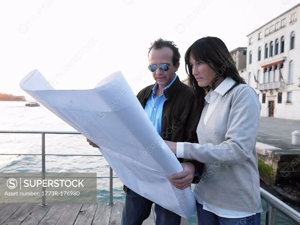 Couple looking at architect´s blueprint Venice, Italy
