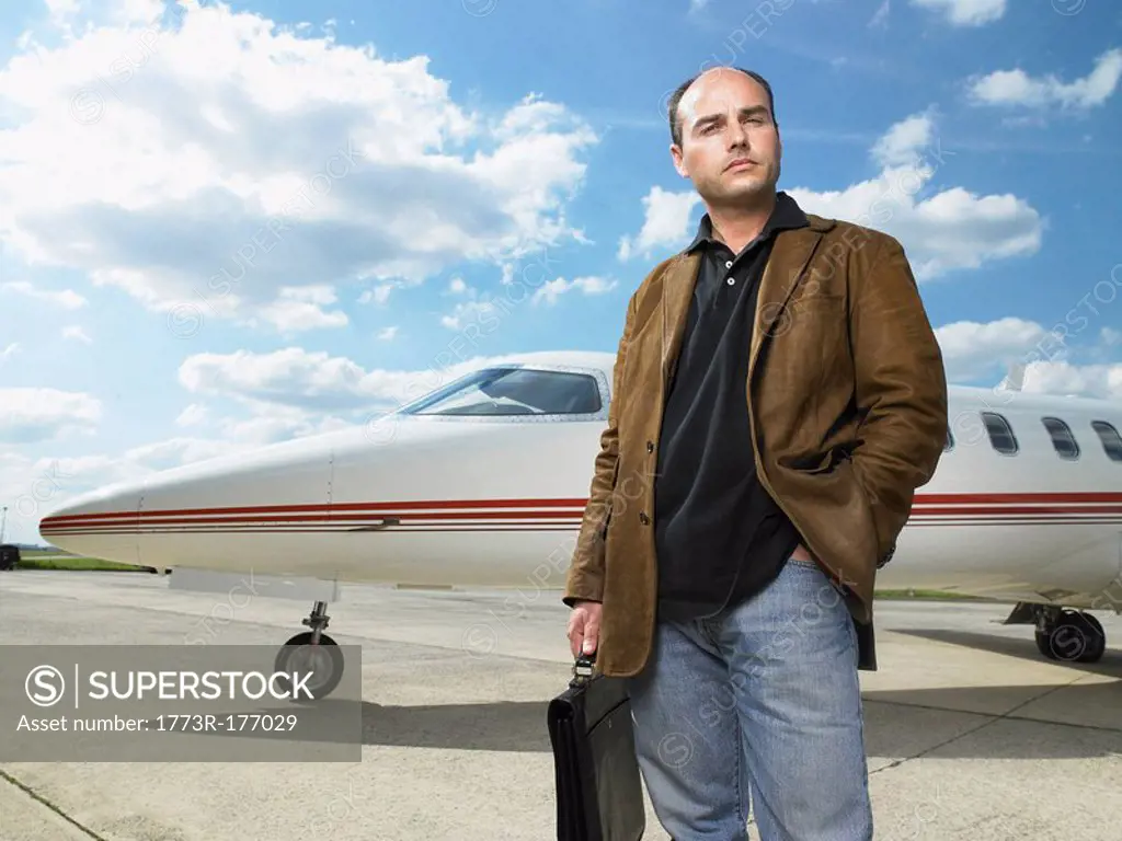 Man standing in front of private jet