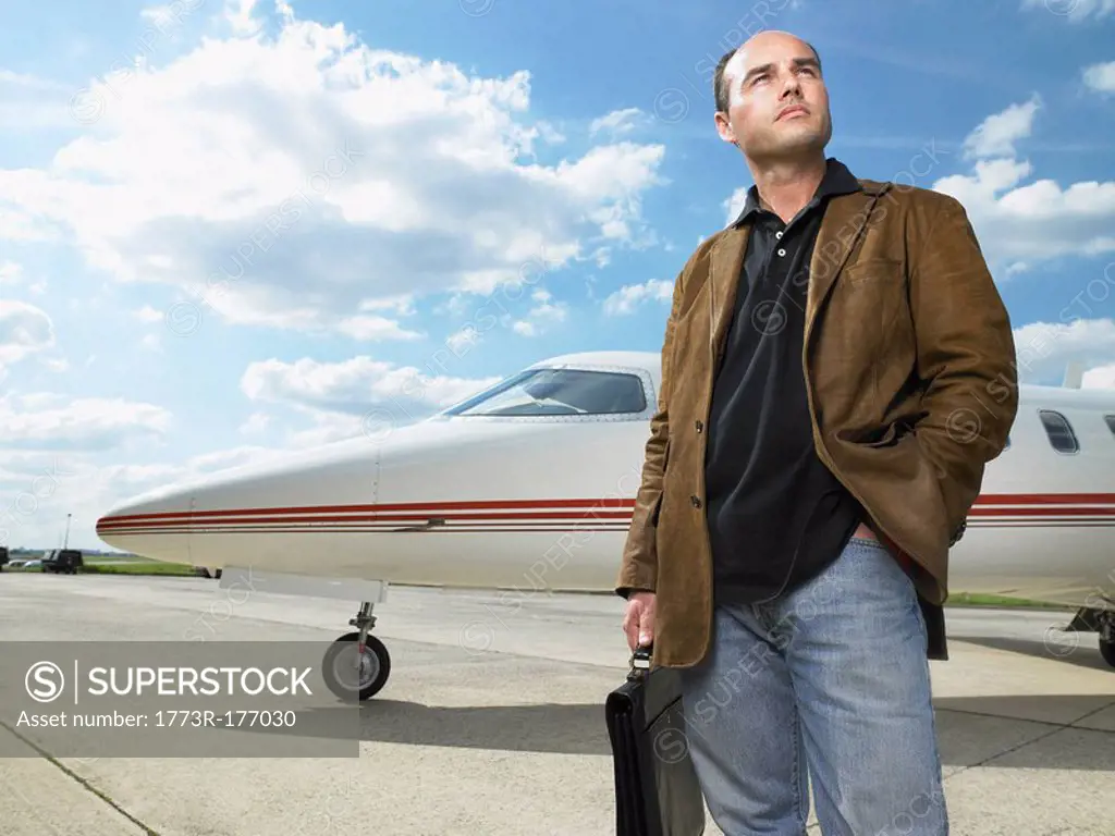 Man standing next to private jet