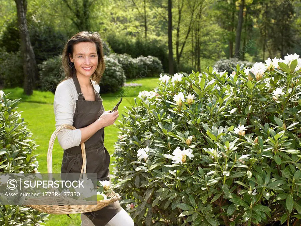 Woman gardening outdoors smiling