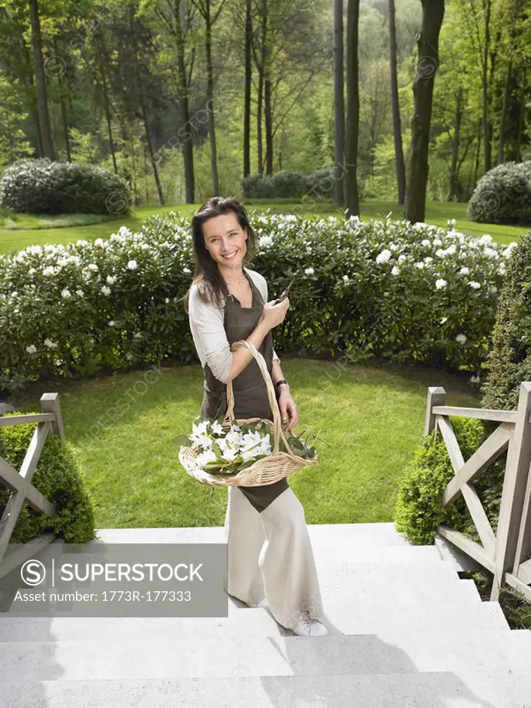 Woman gardening outdoors smiling