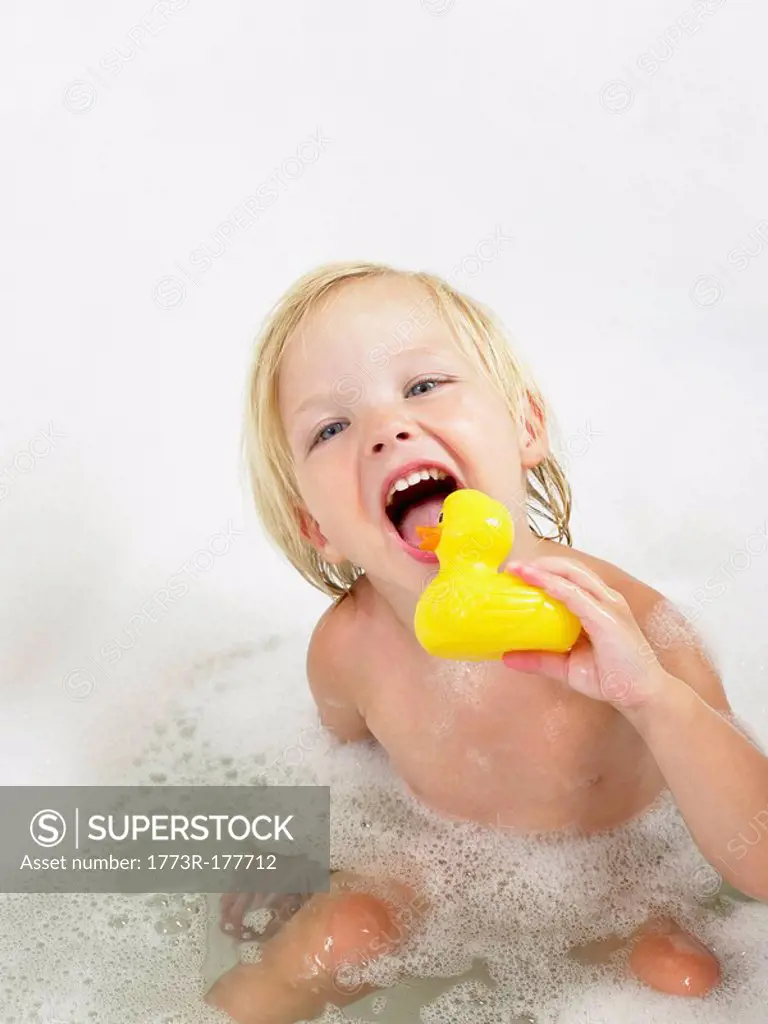Little girl taking a bath yellow duck