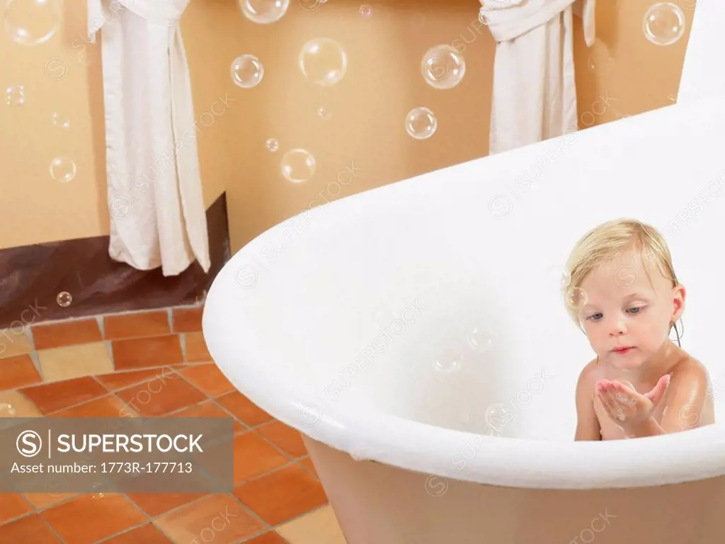 Little girl taking a bath bubbles