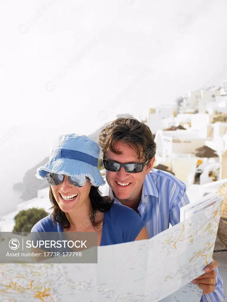 Couple looking at a map, laughing