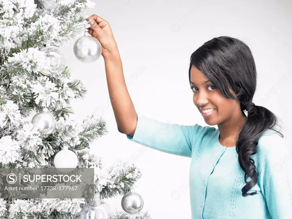 Woman hanging Christmas decoration