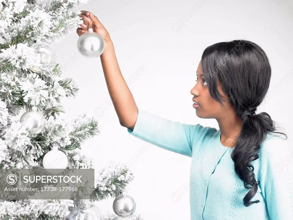 Woman hanging Christmas decoration