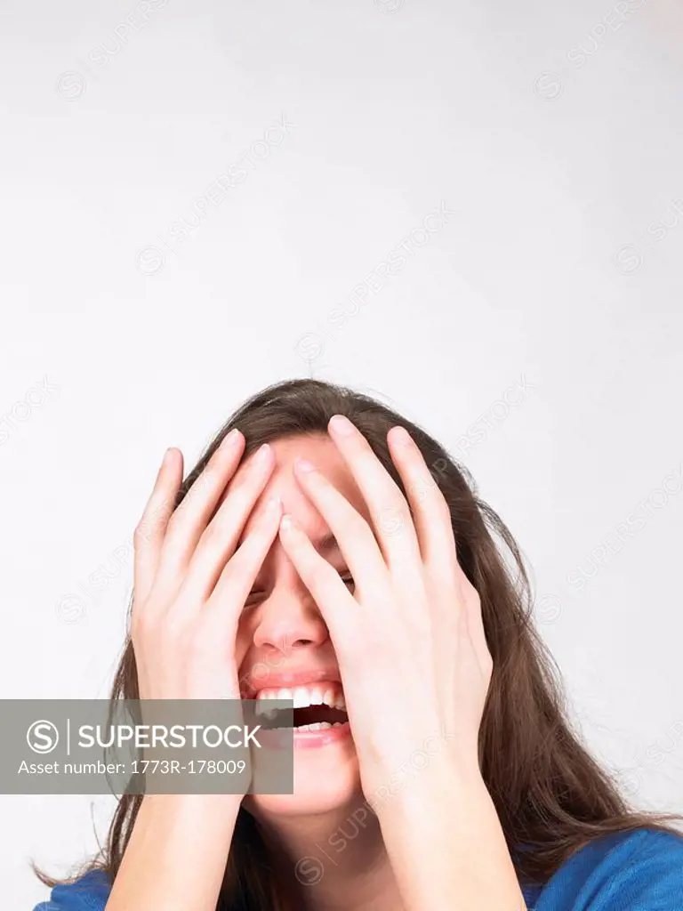 Woman hiding her eyes with hands