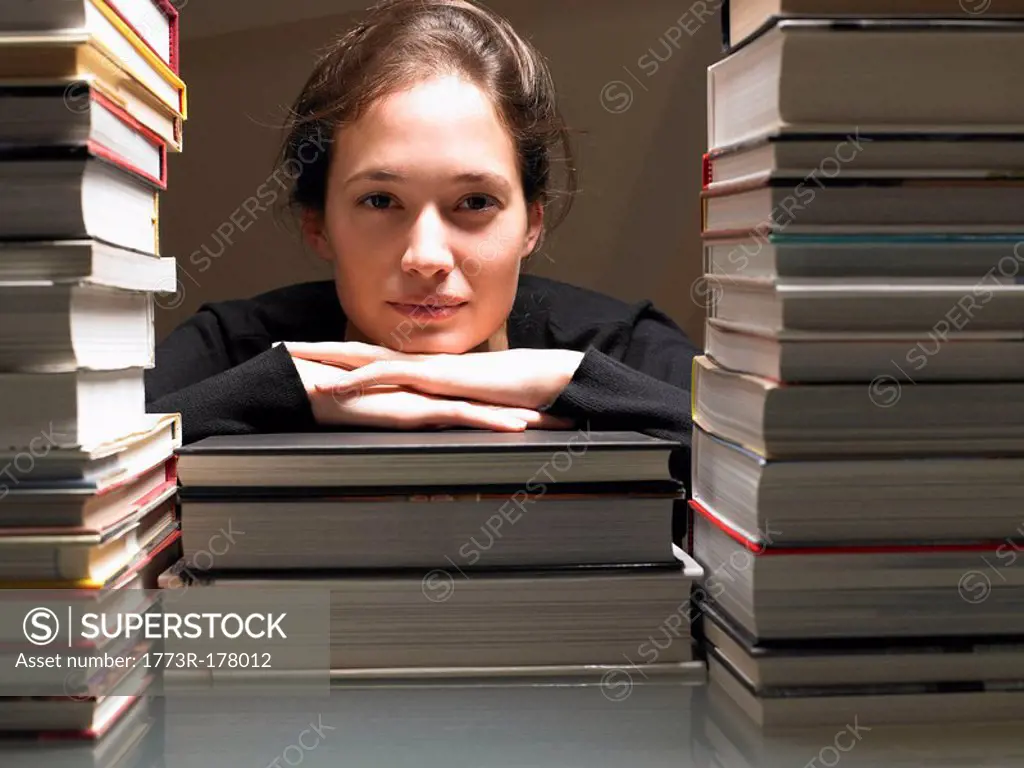 Woman resting on books