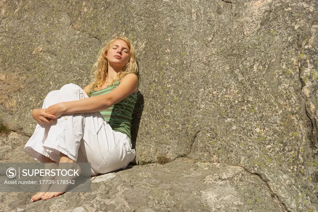 Young Woman sitting on rocks