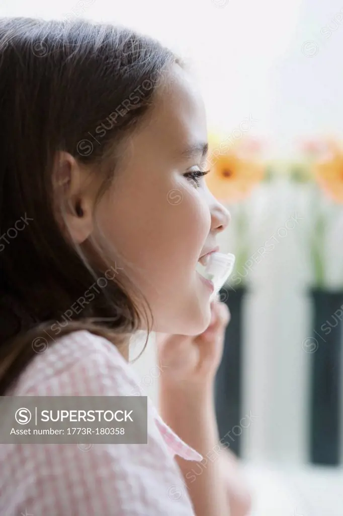 Portrait of a girl brushing teeth