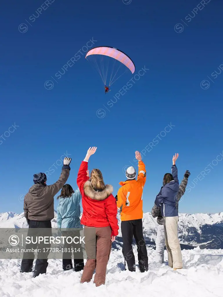 Group waving at parachutist