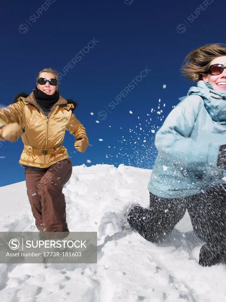 Young women running in snow