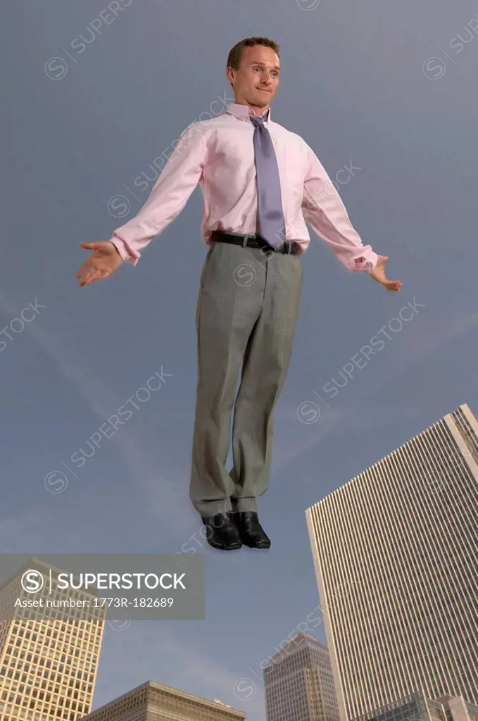 Businessman in the air with city in the background