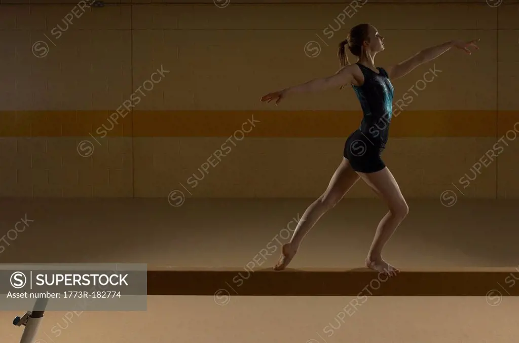 Teenage gymnast 16-18 performing on balance beam