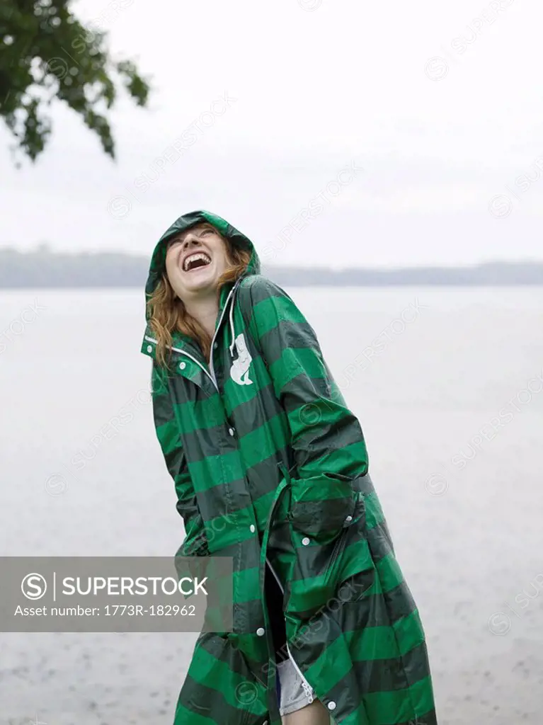 Woman with raincoat on in the rain