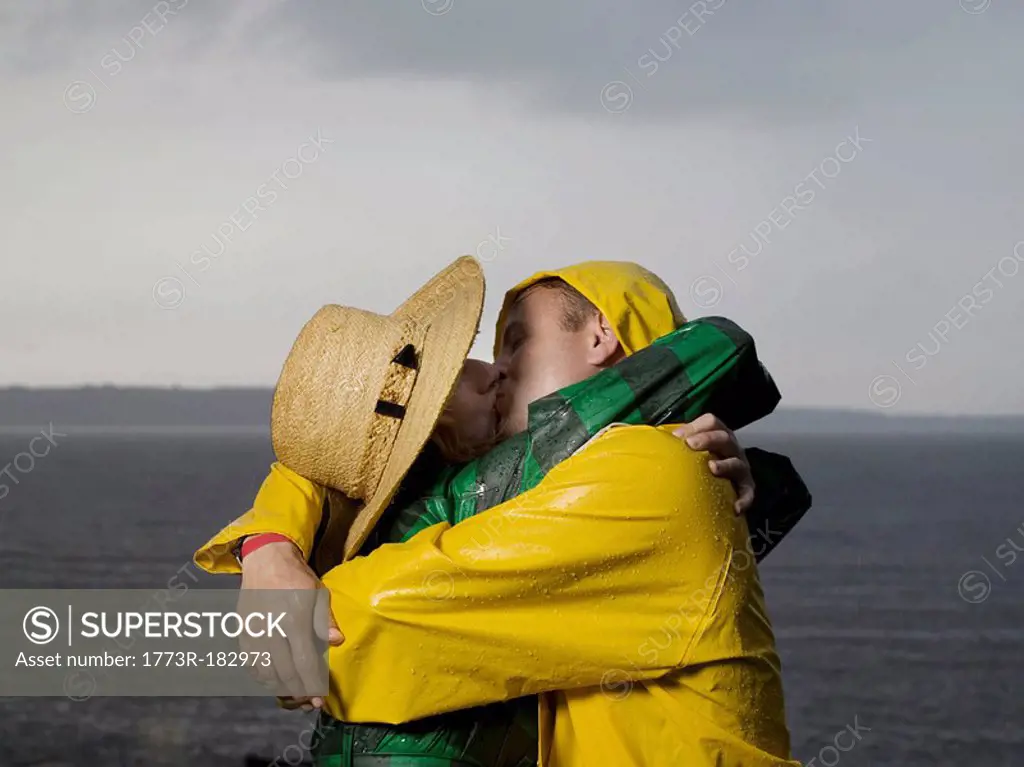 Couple kissing and hugging in the rain