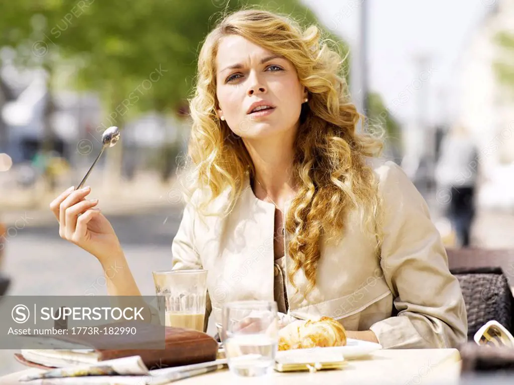 Woman eating at an outdoor restaurant